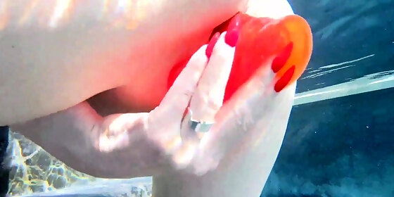 red xxx fucks her pussy with a toy in the pool