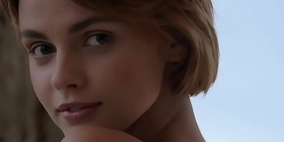 short haired stunner presents her shaved pussy outdoors