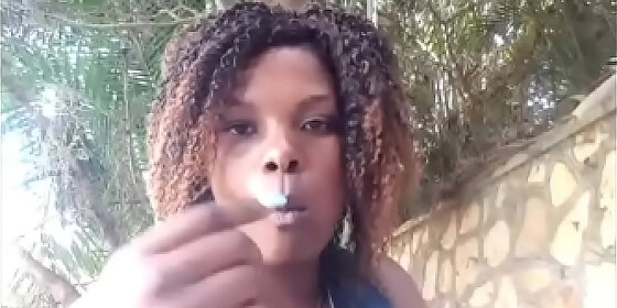 haitian girl eating at a plain air restaurant showing her boobs