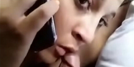 talking to boyfriend on phone and sucking lover