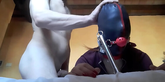 tied to a machine masked and hooded she has to suck a big cock