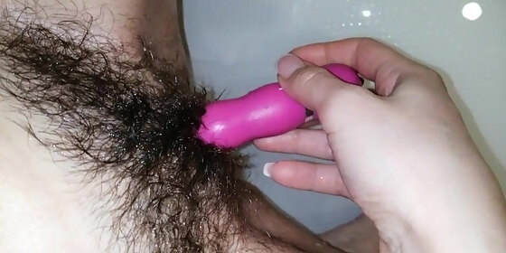 hairy pussy plays with a vibrator and gets an orgasm in the bathroom
