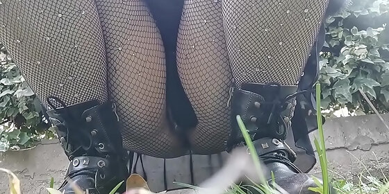 your m wants to piss in a public garden so she bends over and shows you her pussy under a pair of fishnet stockings