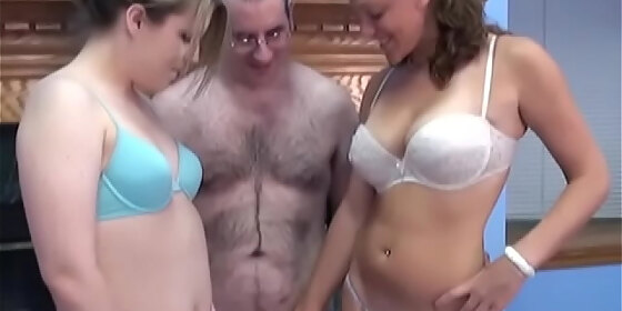 two lustful bitches a brunette and a redhead passionately suck and lick the cock of an excited man with glasses