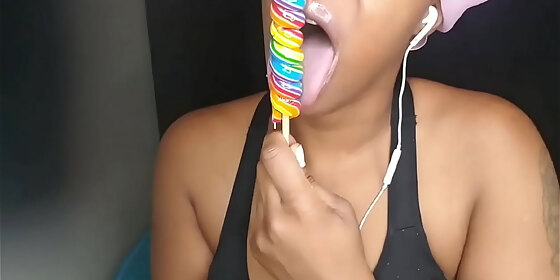 cute ebony chick sucking lollipop