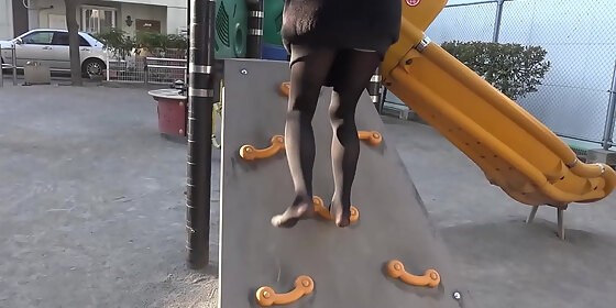 girl walks on the sand in the park in black tights