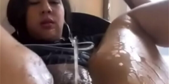 latina squirting next to the window as a fountain