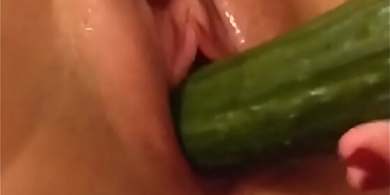 aestrith doll having fun with a cucumber dripping wet close up