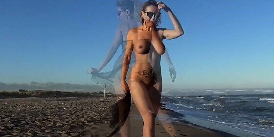 lovely blonde girl fingering pussy on a public beach