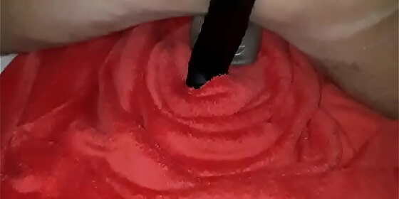 rubbing her parting and her little oil filled hole on a big dildo