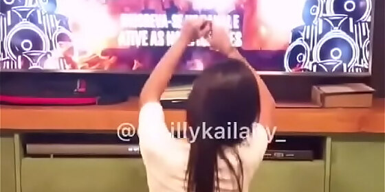 brunette dancing in shorts at home