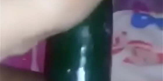 salvadoran woman poking a cucumber
