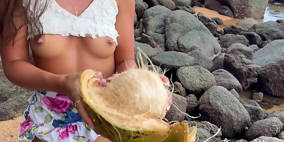 naked girl found a coconut on a public beach and poured the juice over her body